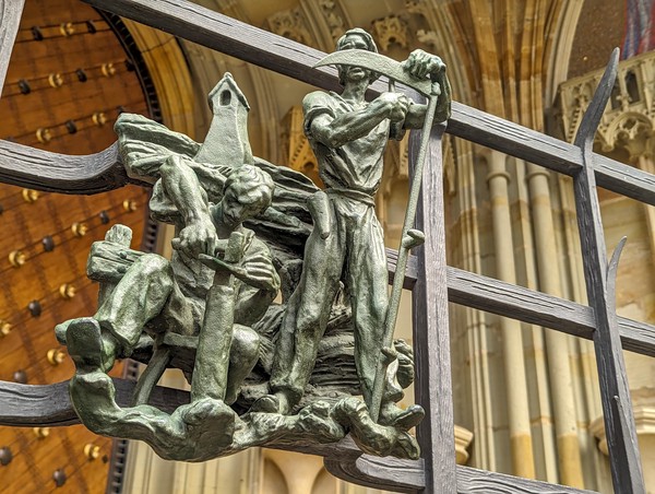 One of the twelve bronzes outside the south transept representing both the signs of the zodiac and the months of the year by Jaroslav Horejc.  This one is cancer / early summer, hence the sharpening of the scythe.